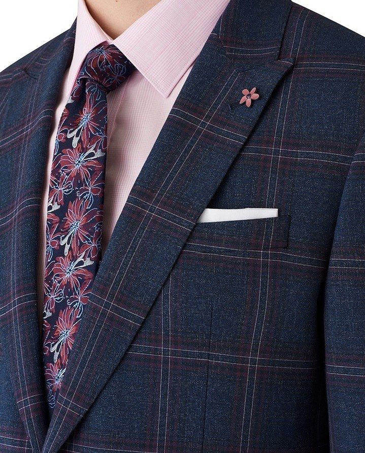 A navy windowpane three-piece suit with a pink shirt, tie and pocket square